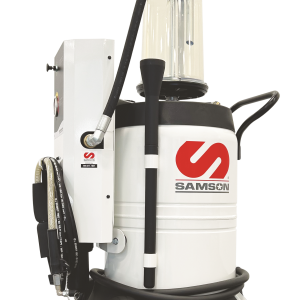 A white industrial vacuum machine with a clear container, black hoses, wheels, and the red SAMSON logo on the front. The control panel and lubrication equipment attachments are visible on the left side.